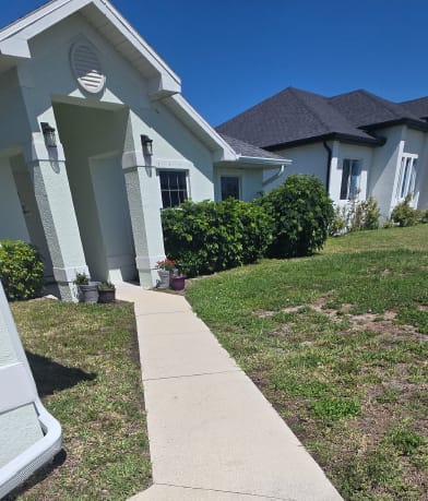 Exterior entry walkway and lawn area reviewed during surface preparation