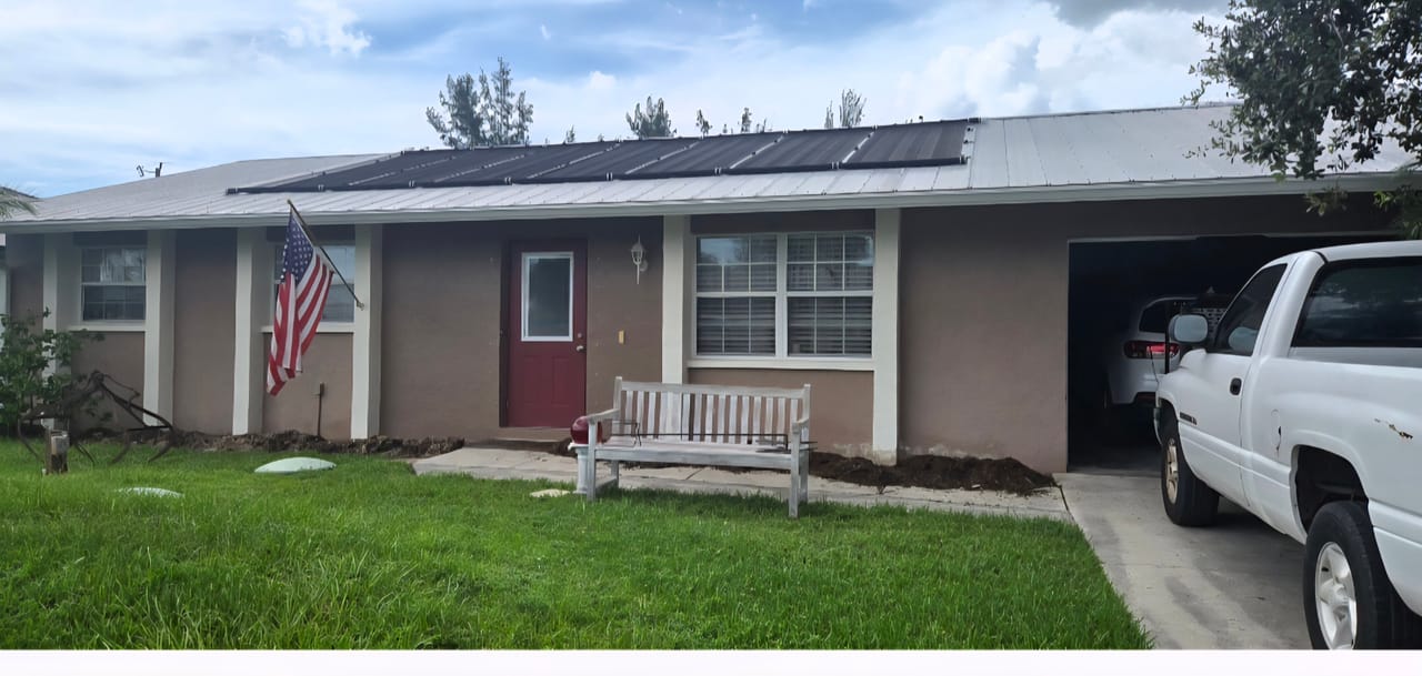 Before photo of a Southwest Florida home exterior with original wall color, trim, and red front door