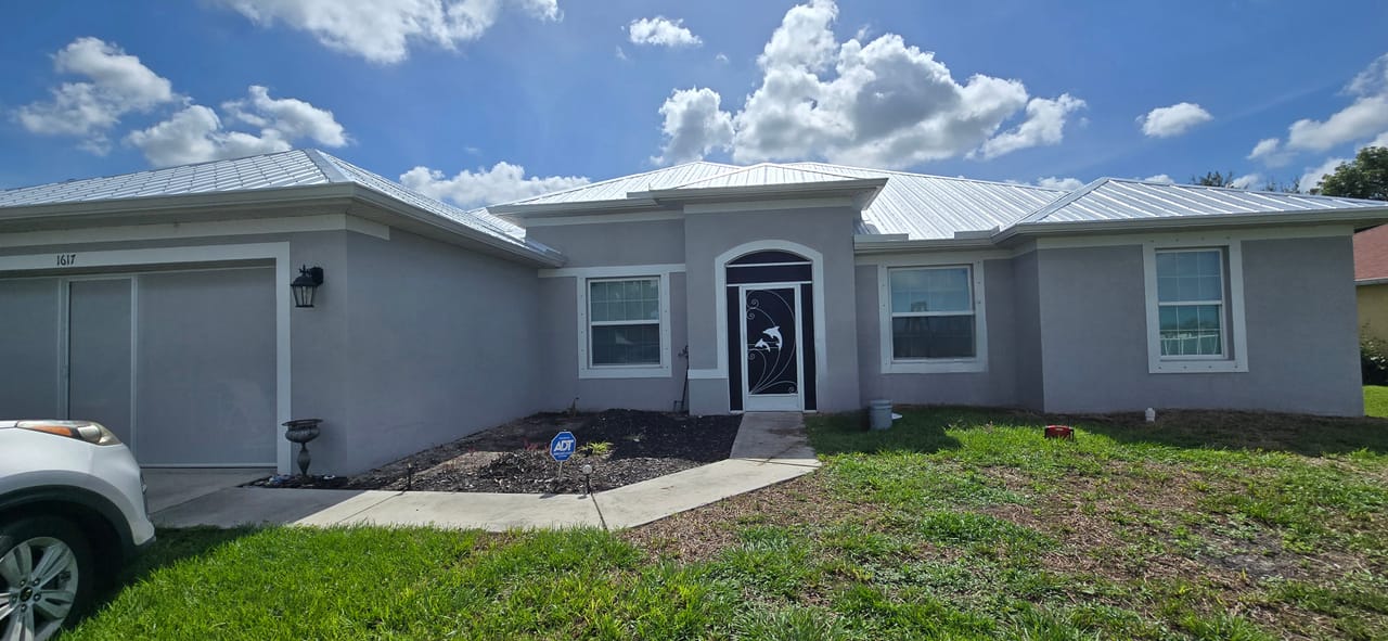 Before photo of a Southwest Florida home exterior before the updated gray paint finish