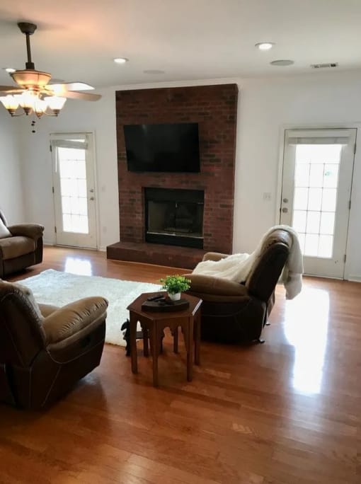 After photo of a brighter living room interior wall finish with natural light and fireplace wall